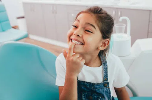 young girl showing off her pretty smile with straight teeth