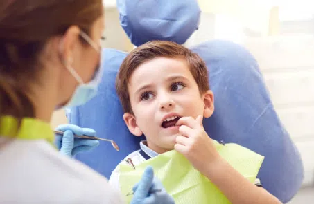 young boy during a pediatric dental cleaning visit. 